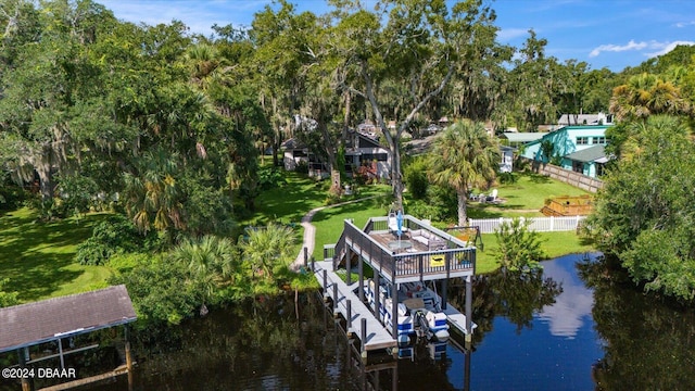 view of dock featuring a water view and a yard