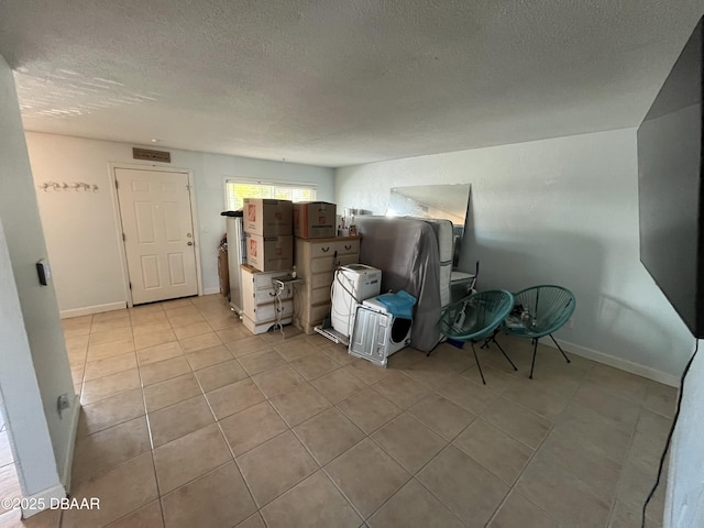 411 N Halifax Ave Unit 203, Daytona Beach, FL 32118 - living area with a textured ceiling and tile patterned floors