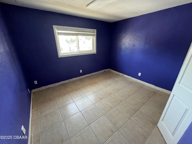 411 N Halifax Ave Unit 203, Daytona Beach, FL 32118 - spare room with tile patterned floors and a textured ceiling