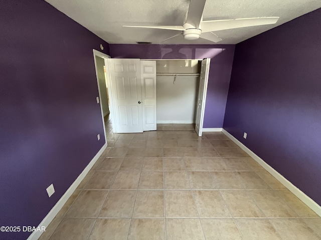 411 N Halifax Ave Unit 203, Daytona Beach, FL 32118 - unfurnished bedroom featuring a textured ceiling, tile patterned floors, a closet, and a ceiling fan