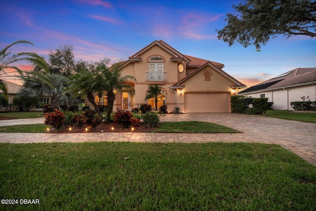 view of front of home with a garage and a yard