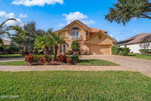 mediterranean / spanish-style house with a front lawn