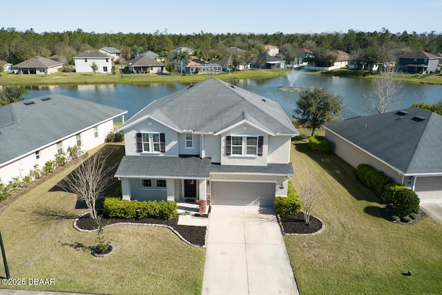 birds eye view of property with a water view and a residential view