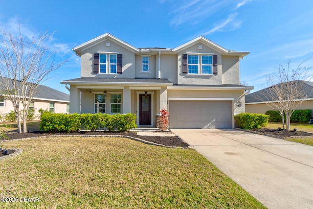 traditional home with a garage, a front yard, driveway, and stucco siding