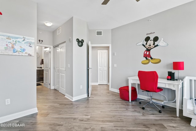 office space featuring ceiling fan and light hardwood / wood-style floors