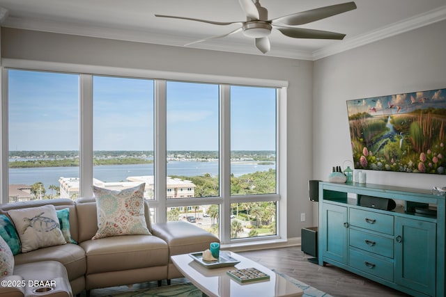 living room with hardwood / wood-style flooring, ceiling fan, a water view, and ornamental molding