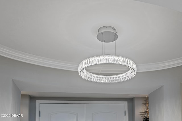 room details featuring crown molding and an inviting chandelier