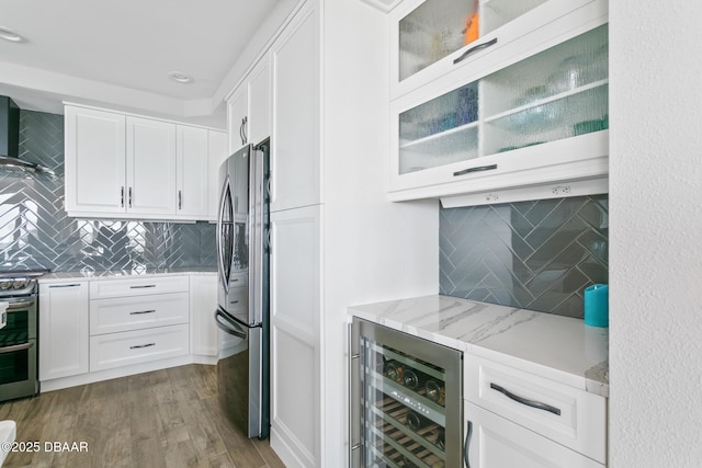 kitchen with white cabinetry, wine cooler, light stone counters, and stainless steel appliances