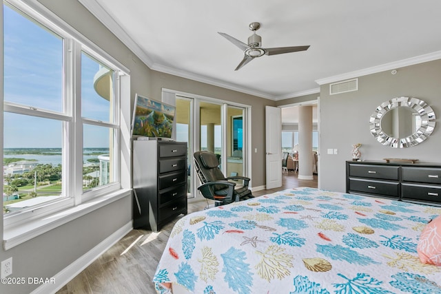 bedroom featuring multiple windows, ceiling fan, light hardwood / wood-style flooring, and ornamental molding