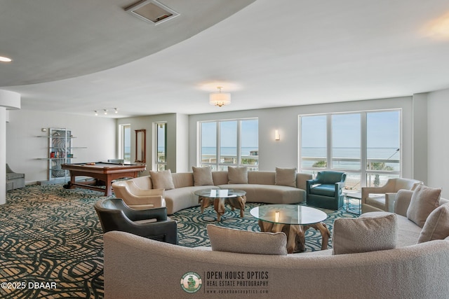 carpeted living room featuring a water view and pool table