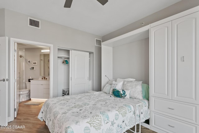 bedroom with connected bathroom, ceiling fan, and dark hardwood / wood-style floors