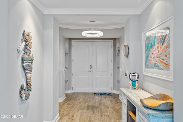 doorway with crown molding and light hardwood / wood-style flooring