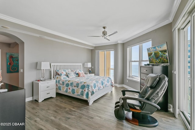 bedroom with hardwood / wood-style floors, ceiling fan, and crown molding