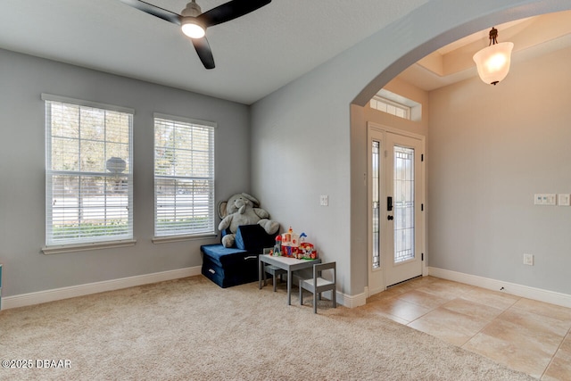 422 Holly Oak Blvd, Deland, FL 32724 - entryway featuring arched walkways, a ceiling fan, light colored carpet, and baseboards