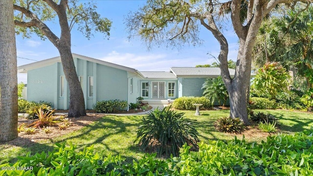 view of front of house with brick siding and a front lawn