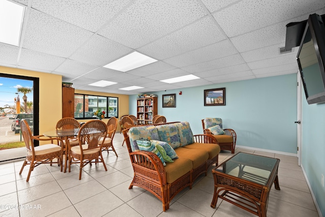 tiled living room with a drop ceiling