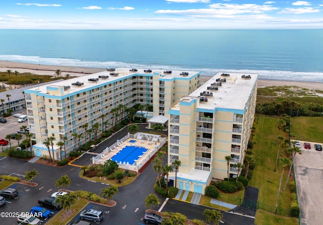 drone / aerial view featuring a water view and a beach view