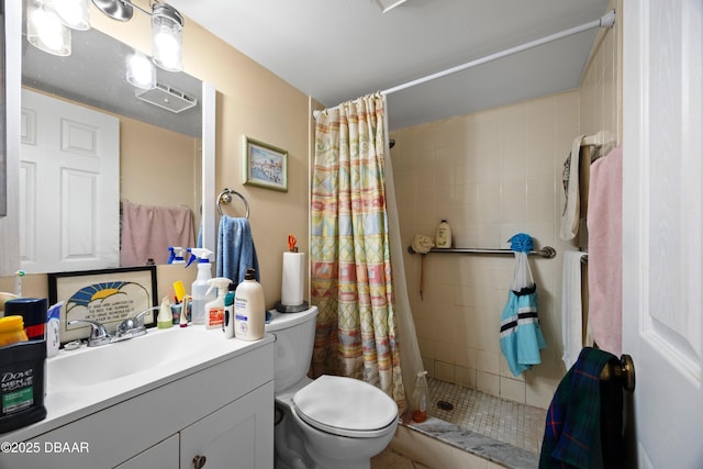 bathroom with toilet, vanity, and a shower with shower curtain