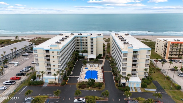 birds eye view of property featuring a water view and a view of the beach