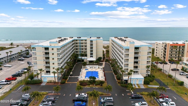 drone / aerial view with a beach view and a water view