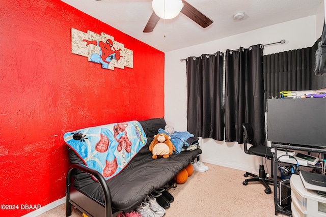 carpeted office space featuring ceiling fan