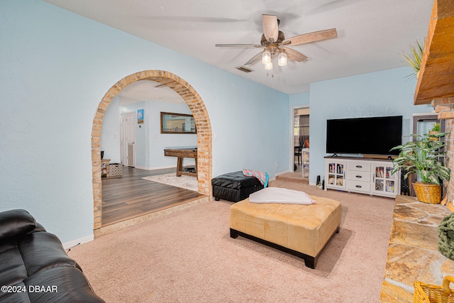 living room featuring hardwood / wood-style floors and ceiling fan