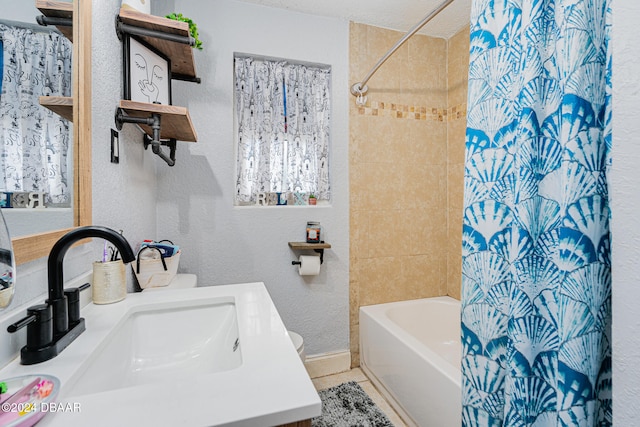 bathroom with vanity, tile patterned floors, a textured ceiling, and shower / bath combo