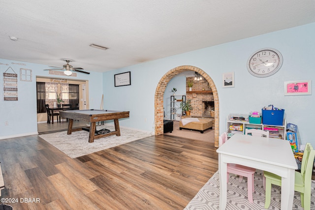 rec room with hardwood / wood-style floors, a textured ceiling, and pool table