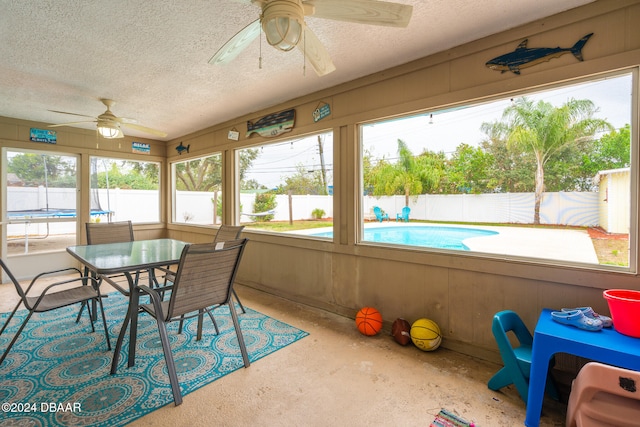 sunroom / solarium featuring ceiling fan and a healthy amount of sunlight