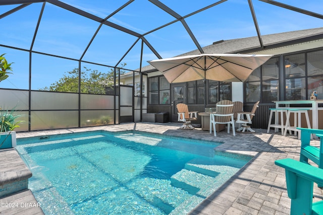 view of swimming pool with a lanai and a patio