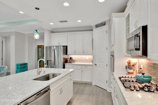 kitchen with stainless steel appliances, light hardwood / wood-style floors, white cabinetry, and sink