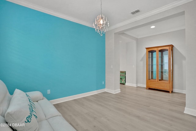 interior space featuring ornamental molding, light wood-type flooring, and a notable chandelier