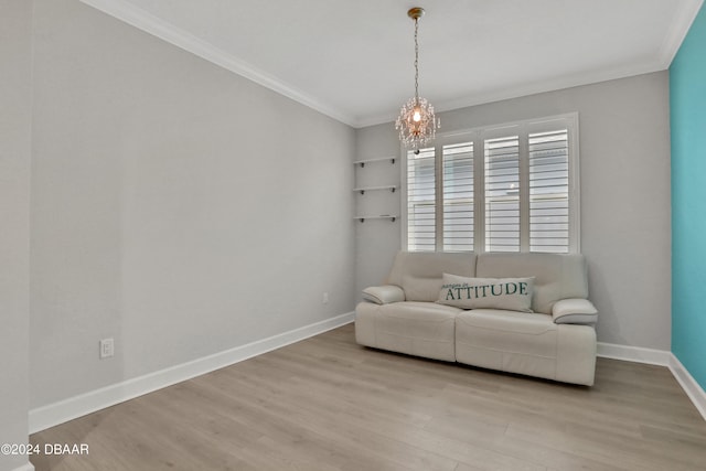 sitting room with ornamental molding, a notable chandelier, and light hardwood / wood-style floors