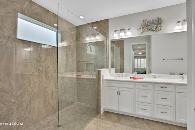 bathroom with vanity and a tile shower