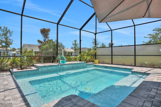 view of pool featuring glass enclosure