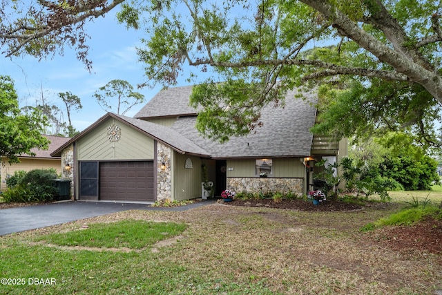 view of front of property with driveway, stone siding, an attached garage, and a shingled roof