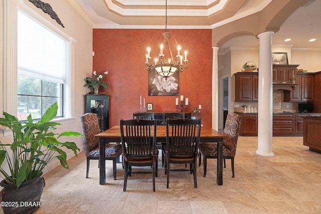 202 Willow Oak Way, Palm Coast, FL 32137 - dining space featuring arched walkways, decorative columns, a chandelier, crown molding, and a tray ceiling