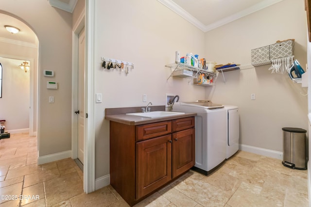 202 Willow Oak Way, Palm Coast, FL 32137 - clothes washing area with washer and dryer, ornamental molding, stone tile flooring, cabinet space, and baseboards