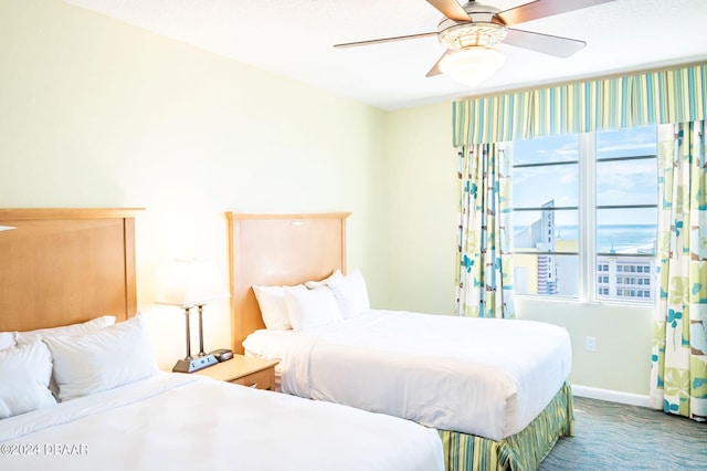 carpeted bedroom with baseboards and ceiling fan