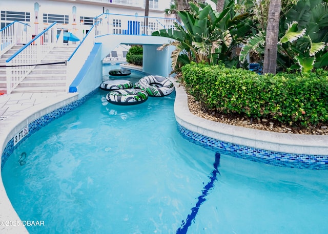 view of pool featuring stairs