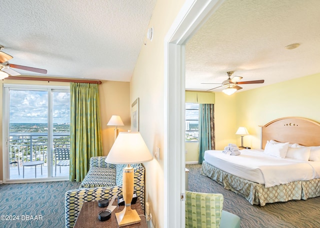 bedroom with access to exterior, a textured ceiling, ceiling fan, and carpet floors