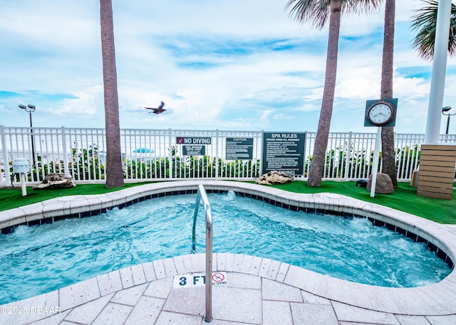 view of swimming pool with fence