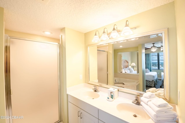 ensuite bathroom featuring a sink, a textured ceiling, a shower stall, and ensuite bathroom