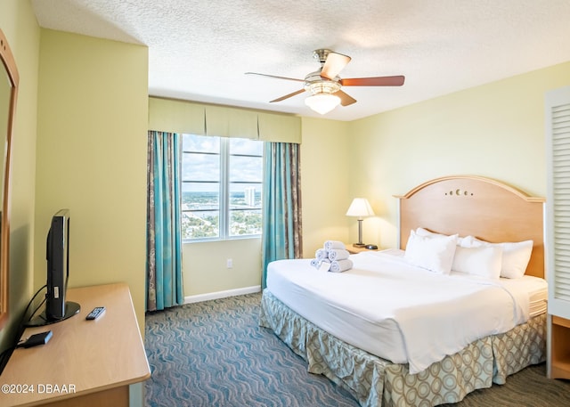 carpeted bedroom featuring a ceiling fan, baseboards, and a textured ceiling