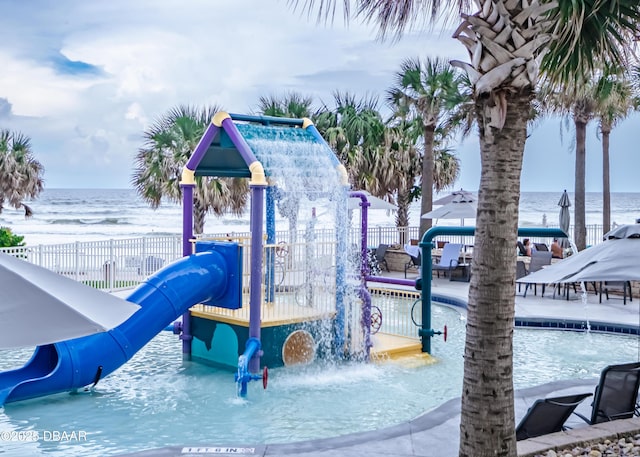 communal playground with a water view and fence