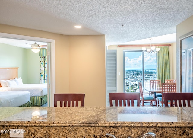 dining area with a chandelier and a textured ceiling