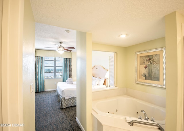 full bathroom featuring a ceiling fan, a tub with jets, baseboards, a textured ceiling, and connected bathroom