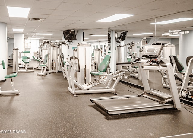 exercise room featuring visible vents and a paneled ceiling