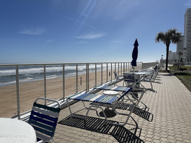 exterior space with a water view and a view of the beach