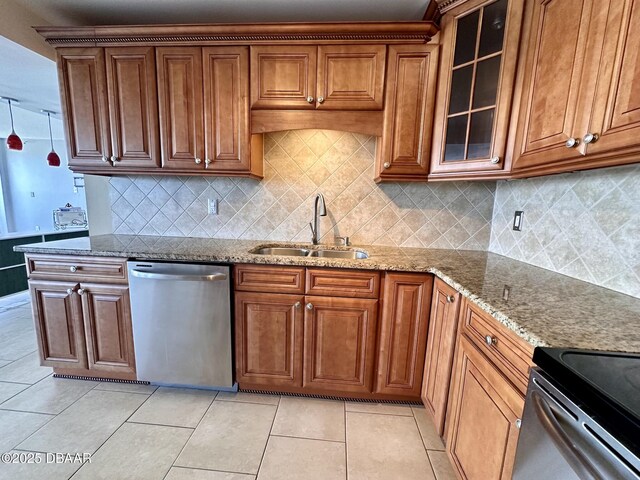 kitchen featuring light tile patterned floors, light stone counters, a sink, stainless steel dishwasher, and glass insert cabinets